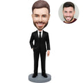 Custom bobblehead for men in all black suit with black tie one hand in pocket – personalized executive gift handcrafted from photo