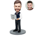 Custom bobblehead for men in navy vest holding laptop with Best Boss screen – personalized boss day gift handcrafted from photo