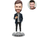 Custom Boss Mode bobblehead for men in navy blazer gray turtleneck holding phone with BOSS MODE nameplate – personalized modern boss gift handcrafted from photo