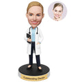 Custom female doctor bobblehead from photo wearing a white coat with stethoscope and medical chart