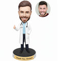 Custom thank you doctor bobblehead from photo wearing a white coat and stethoscope with thumbs-up pose