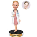 Custom female OB-GYN doctor bobblehead wearing white coat and pink professional dress with stethoscope