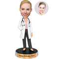 Custom female doctor birthday bobblehead in white coat with stethoscope and Happy Birthday Doc base