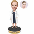 Custom female doctor bobblehead from photo wearing a white coat over a professional dress with stethoscope