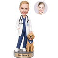 Custom female doctor bobblehead with dog in white coat and navy scrubs with personalized engraved base