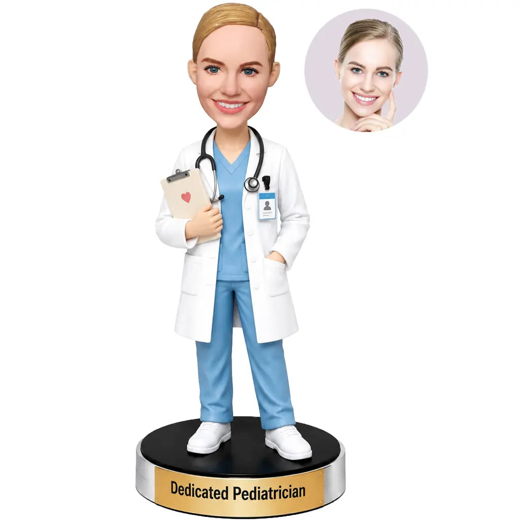 Custom female pediatrician bobblehead in light blue medical scrubs and white coat holding a clipboard