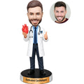 Custom male cardiologist bobblehead in white coat holding an anatomical heart model with stethoscope