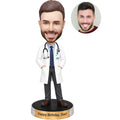 Custom male doctor birthday bobblehead wearing white coat, tie and stethoscope with personalized birthday base