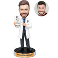 Custom male ophthalmologist bobblehead in white coat holding an eye chart and pointing to the vision test