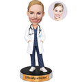 Custom new female doctor bobblehead in white coat and navy scrubs with stethoscope and personalized base