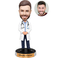 Custom new physician bobblehead from photo wearing a white coat and stethoscope with personalized engraved base