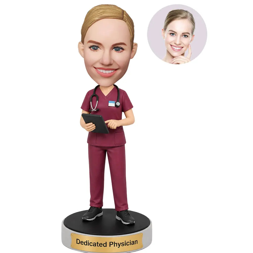 Personalized female doctor bobblehead in burgundy medical scrubs holding a tablet with stethoscope and ID badge