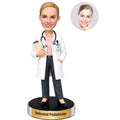 Personalized female pediatrician bobblehead in white coat holding a clipboard with stethoscope