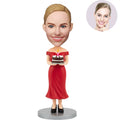 Custom bobblehead birthday gift for her – personalized woman in red off-shoulder dress holding a birthday cake