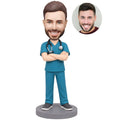 Custom male nurse bobblehead in teal scrubs with stethoscope and crossed arms