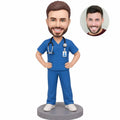 Custom male nurse bobblehead in blue scrubs with stethoscope and ID badge